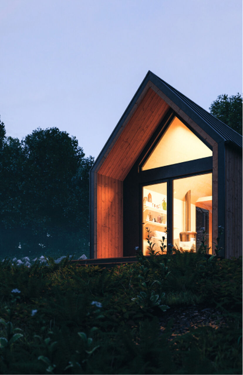 A brightly lit house surrounded by nature.